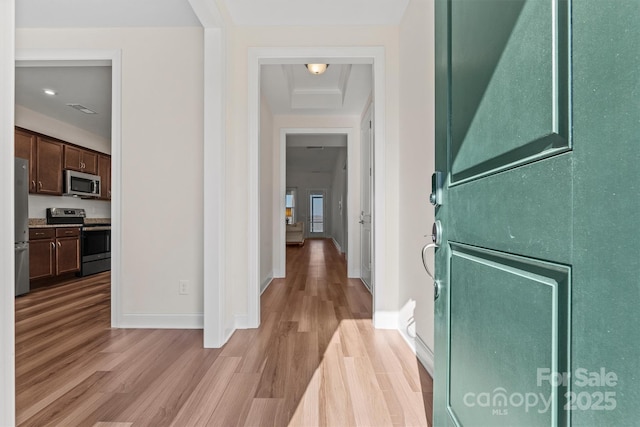 hallway with light hardwood / wood-style floors