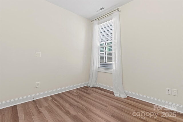 spare room with light wood-type flooring