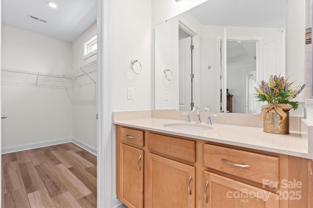 bathroom with hardwood / wood-style floors and vanity