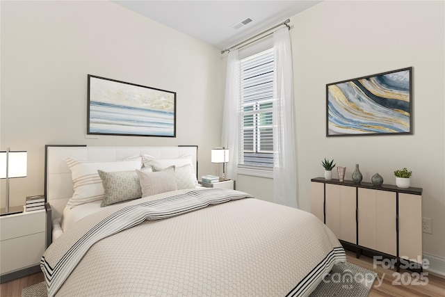 bedroom with hardwood / wood-style floors