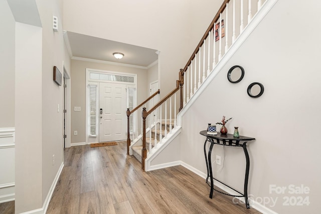 entrance foyer featuring light hardwood / wood-style floors and ornamental molding