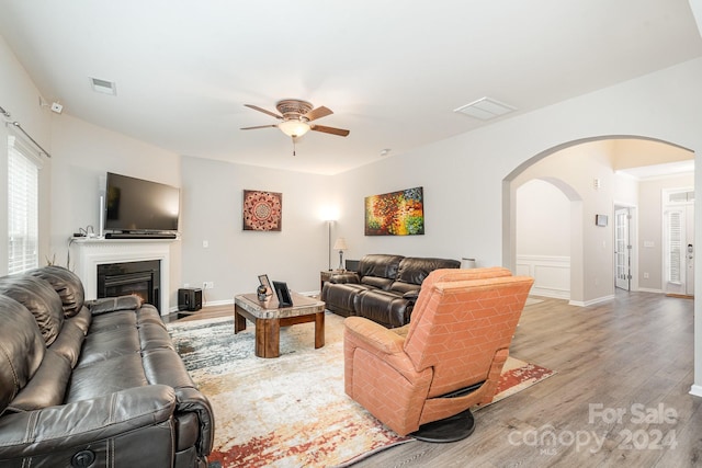 living room with ceiling fan and light hardwood / wood-style flooring