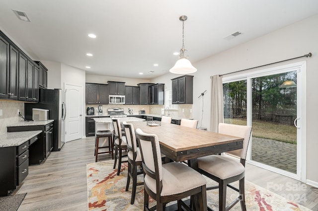 dining space with light hardwood / wood-style floors