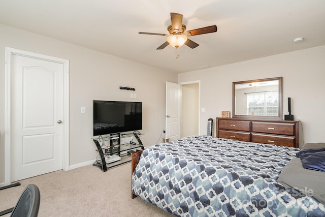 bedroom featuring ceiling fan and light carpet