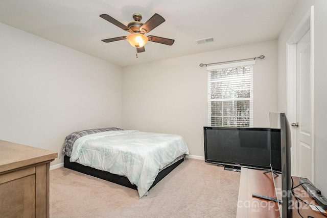 bedroom featuring light colored carpet and ceiling fan