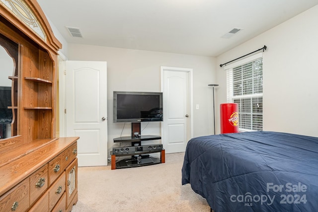 bedroom featuring light carpet