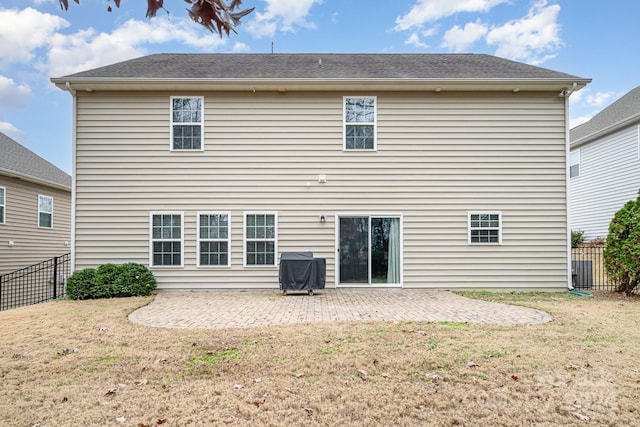 back of property featuring a yard and a patio area