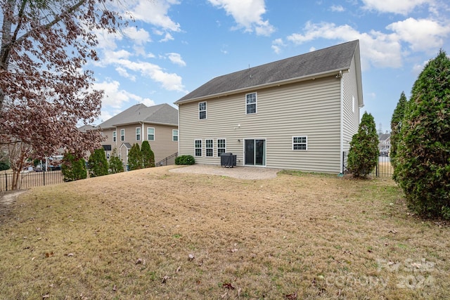 back of house featuring a yard