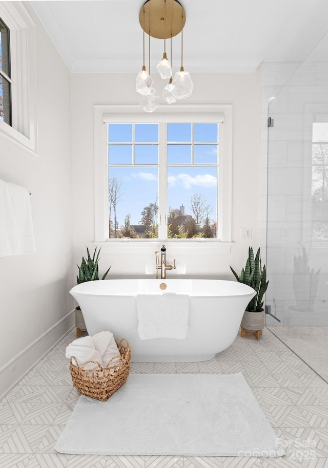 bathroom featuring ornamental molding and separate shower and tub