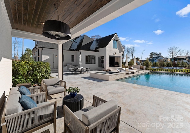 view of swimming pool with an outdoor living space, an in ground hot tub, and a patio area