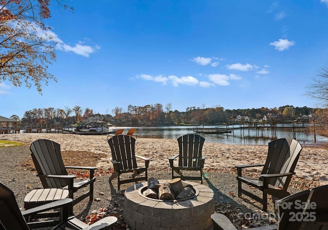 view of patio with a water view and an outdoor fire pit