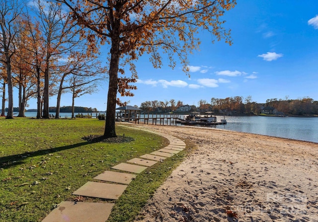 view of community with a water view and a lawn