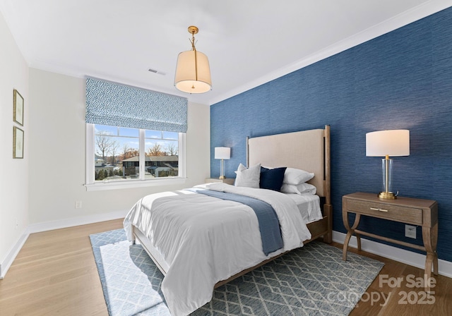 bedroom featuring wood-type flooring and crown molding