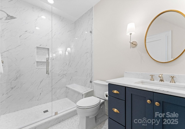 bathroom with vanity, a shower with shower door, and toilet