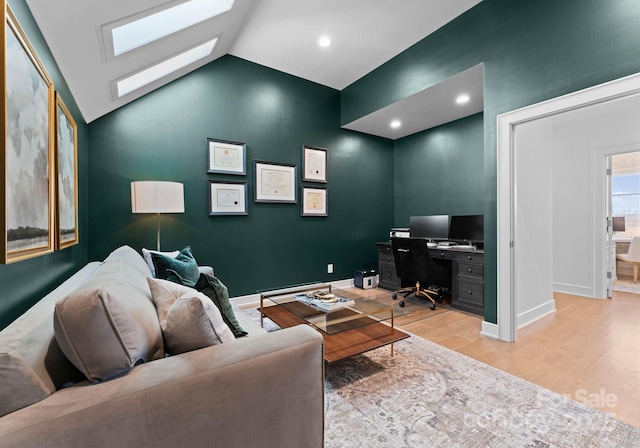 living room with light hardwood / wood-style flooring and vaulted ceiling with skylight