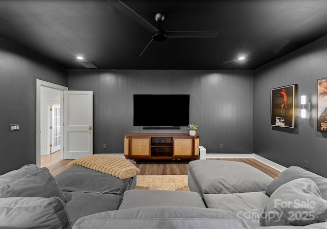 home theater room featuring ceiling fan and light wood-type flooring