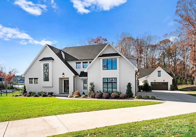 view of front of home with a garage and a front lawn