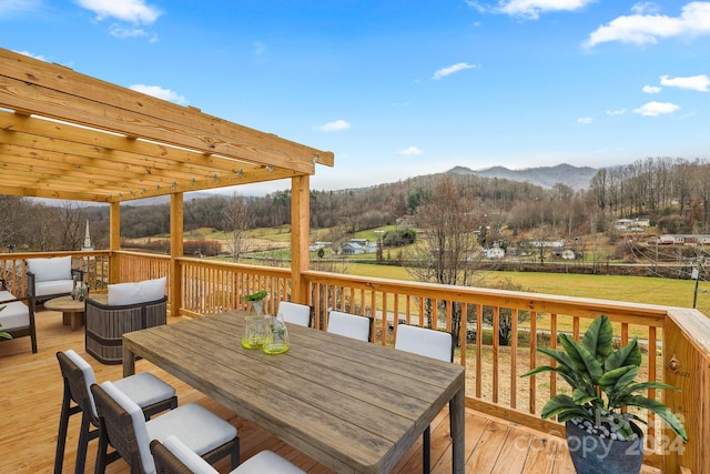 wooden deck with a mountain view and a pergola