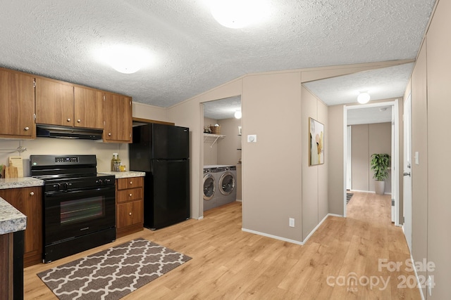 kitchen with separate washer and dryer, light hardwood / wood-style flooring, range hood, lofted ceiling, and black appliances