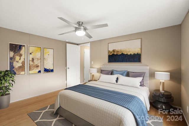 bedroom with light hardwood / wood-style floors and ceiling fan