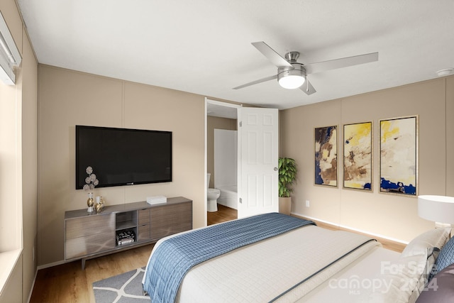 bedroom featuring ceiling fan, wood-type flooring, and ensuite bath