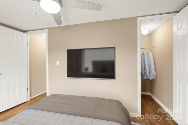 bedroom with ceiling fan and wood-type flooring