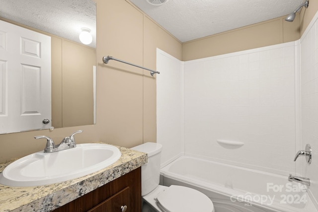 full bathroom with shower / bathing tub combination, vanity, toilet, and a textured ceiling