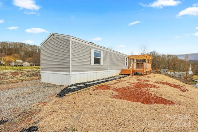 view of property exterior with a deck