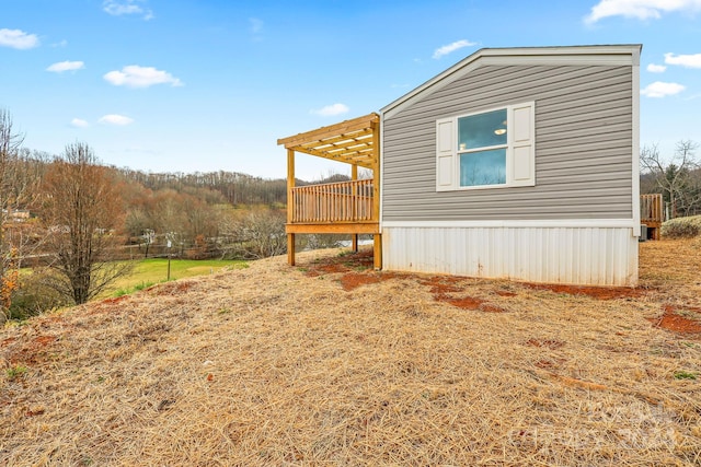 view of property exterior featuring a wooden deck