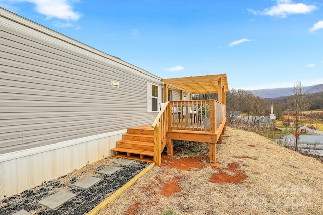 deck featuring a mountain view and a pergola