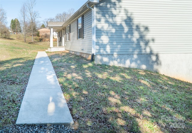 view of property exterior with a yard