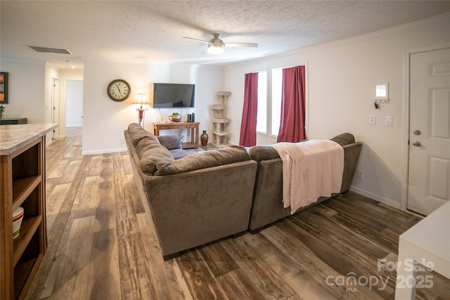 living room with dark hardwood / wood-style flooring, a textured ceiling, ceiling fan, and ornamental molding