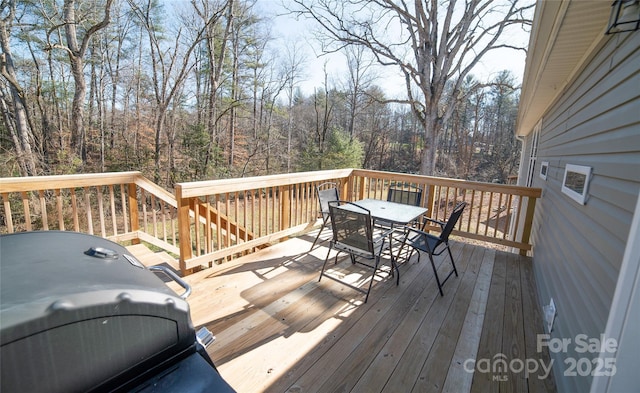 wooden terrace with a grill