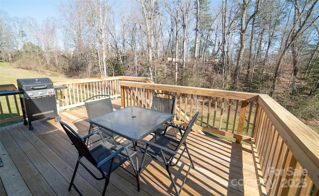 wooden terrace with a grill