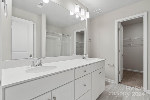 bathroom featuring vanity and an enclosed shower