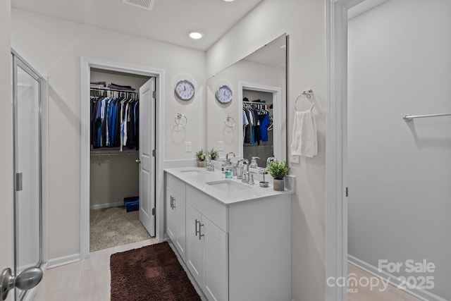 bathroom with tile patterned flooring and vanity