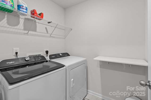 clothes washing area featuring washer and dryer