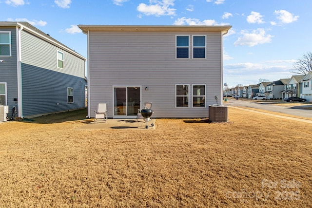 back of property featuring a patio area, a yard, and central AC unit