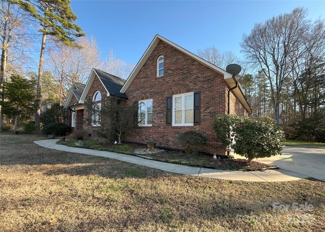 view of home's exterior with a yard