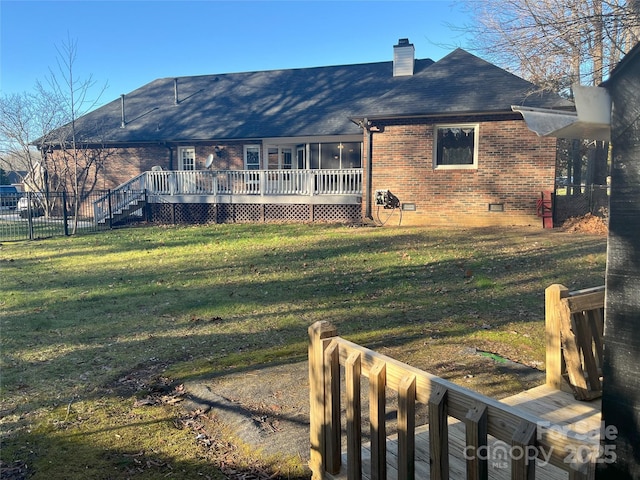 back of house with a lawn and a wooden deck