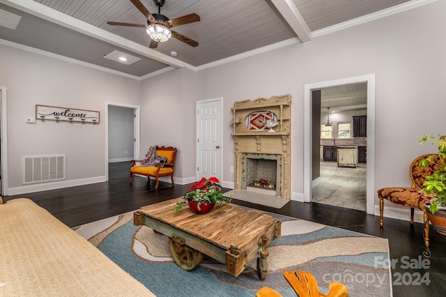 living room featuring dark hardwood / wood-style flooring, ornamental molding, wood ceiling, ceiling fan, and beamed ceiling