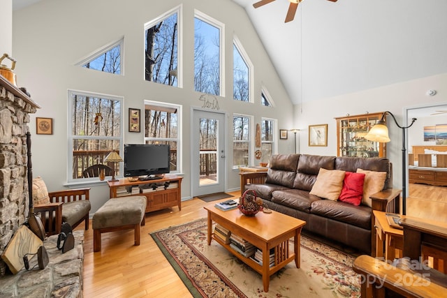 2959/2961 Bearwallow Mountain Rd, Hendersonville, NC 28792 - living room featuring ceiling fan, light hardwood / wood-style floors, a fireplace, and high vaulted ceiling