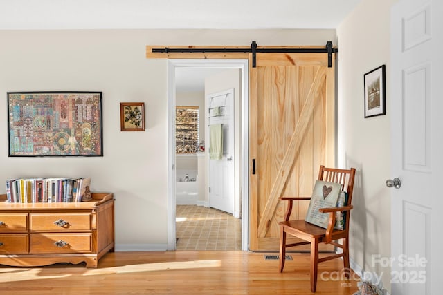 2959/2961 Bearwallow Mountain Rd, Hendersonville, NC 28792 - hall featuring a barn door and light hardwood / wood-style flooring