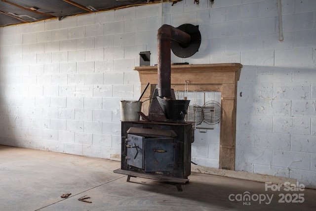 details featuring a wood stove and concrete flooring