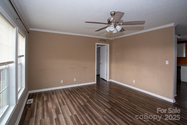 spare room with a textured ceiling, dark hardwood / wood-style flooring, ceiling fan, and ornamental molding