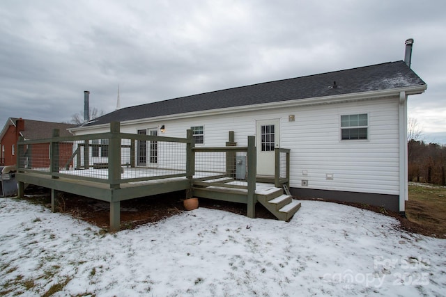 snow covered rear of property featuring a wooden deck