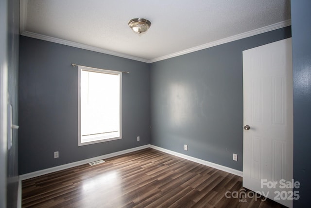 spare room with dark hardwood / wood-style floors, plenty of natural light, and ornamental molding