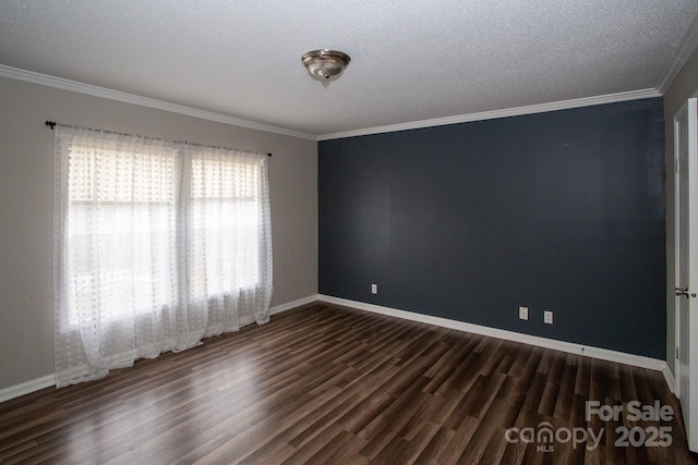 spare room with dark hardwood / wood-style floors, ornamental molding, and a textured ceiling