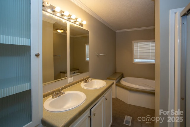 bathroom with a bathtub, vanity, tile patterned floors, ornamental molding, and a textured ceiling