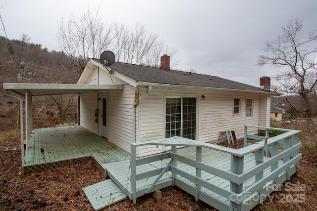 back of property with a wooden deck